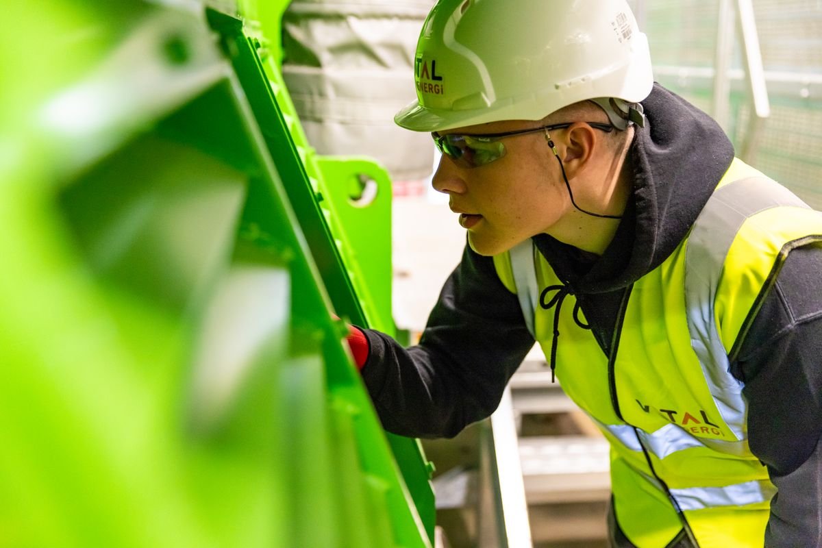 Engineering worker inspecting industrial machinery